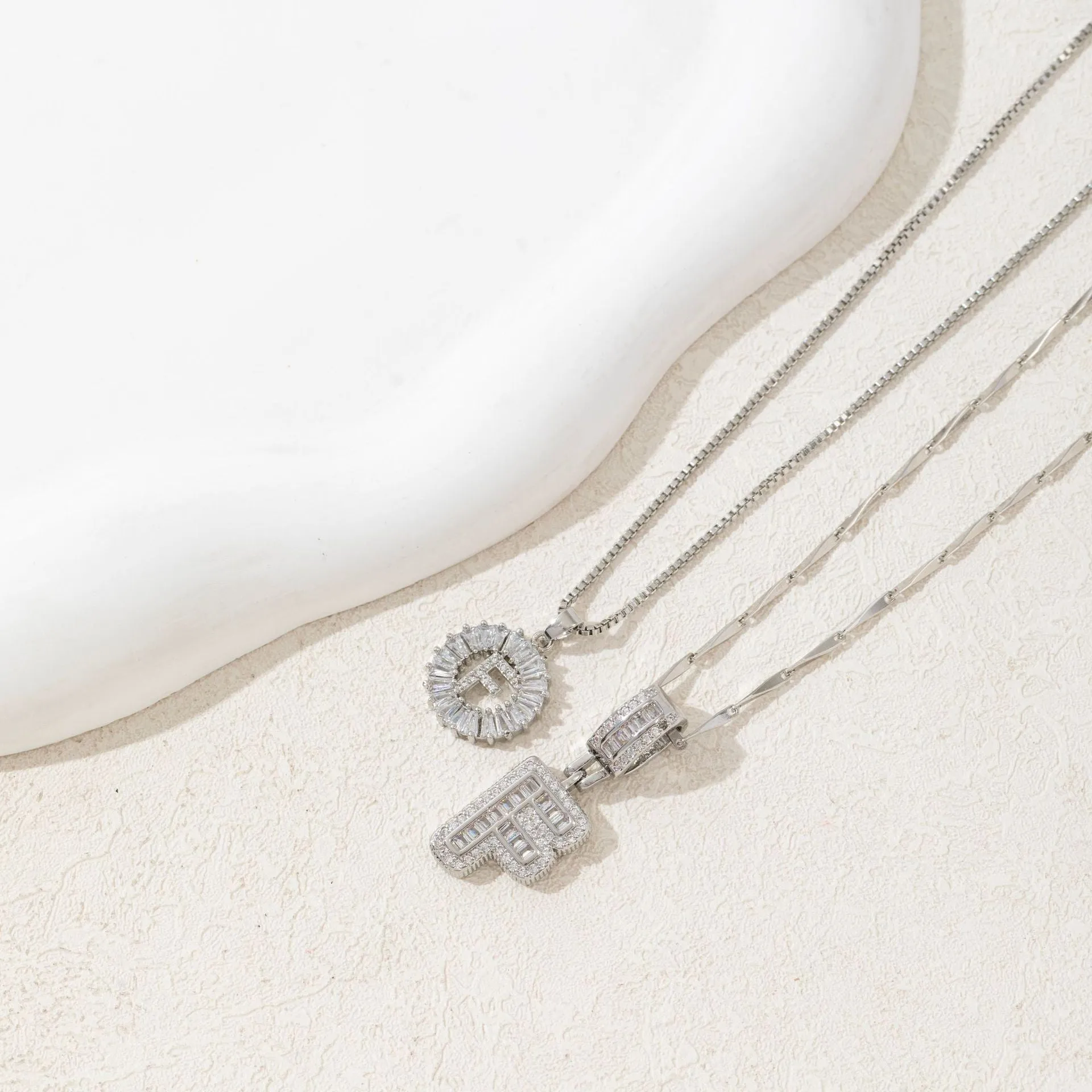 18K gold plated copper alphabet pendant necklace letter A with melon seeds chain on white background