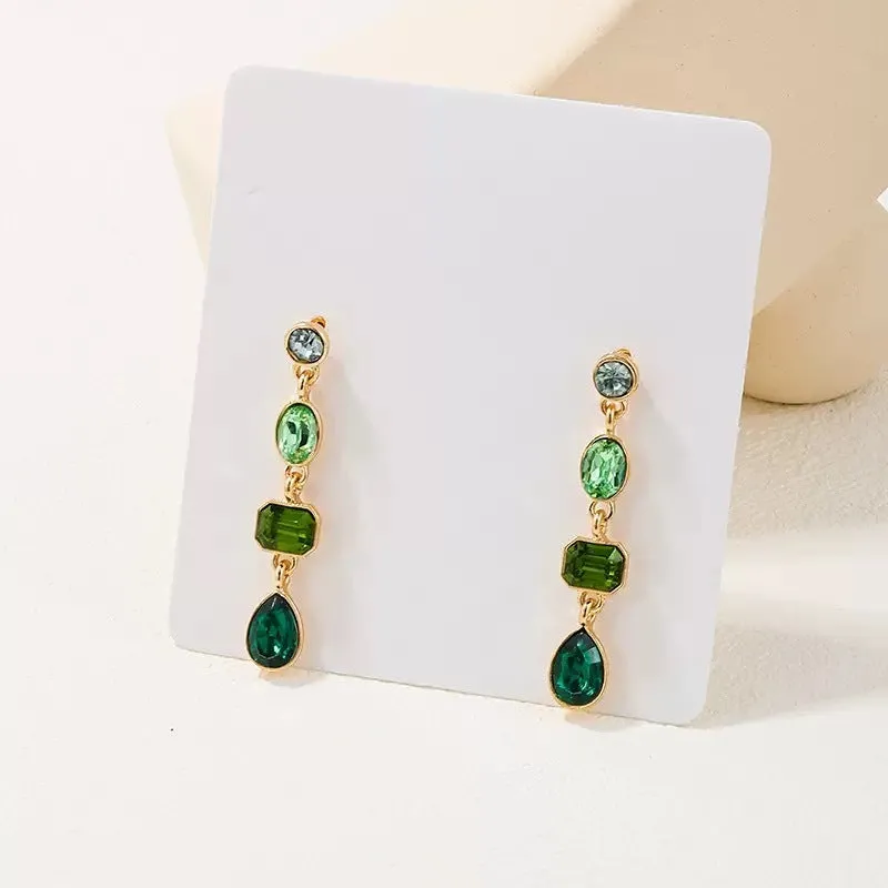 Female green round tassel long geometric earrings on display showing round acrylic and tassel drop
