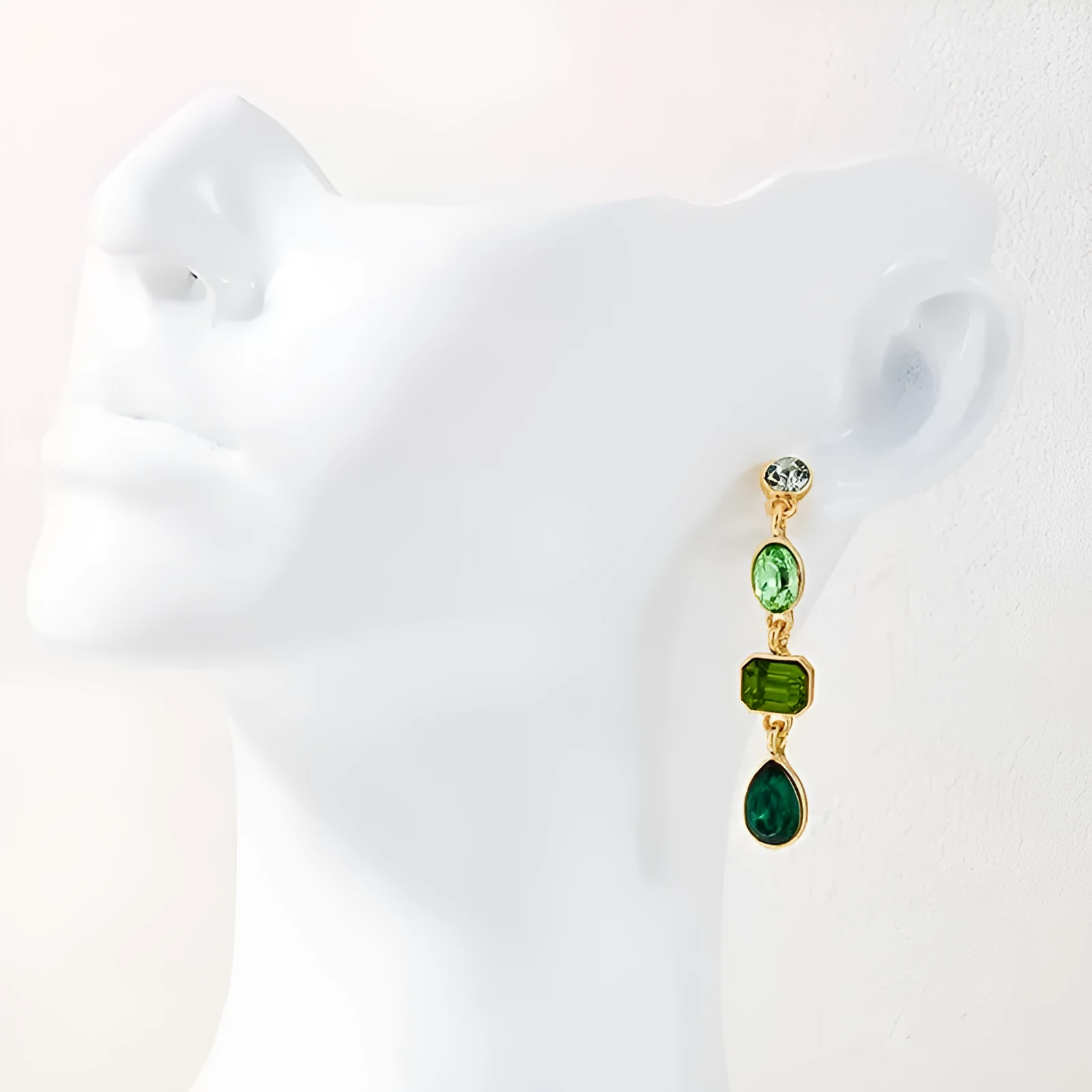 Female green round tassel long geometric earrings on display showing round acrylic and tassel drop