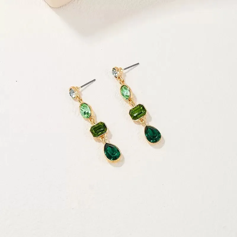 Female green round tassel long geometric earrings on display showing round acrylic and tassel drop