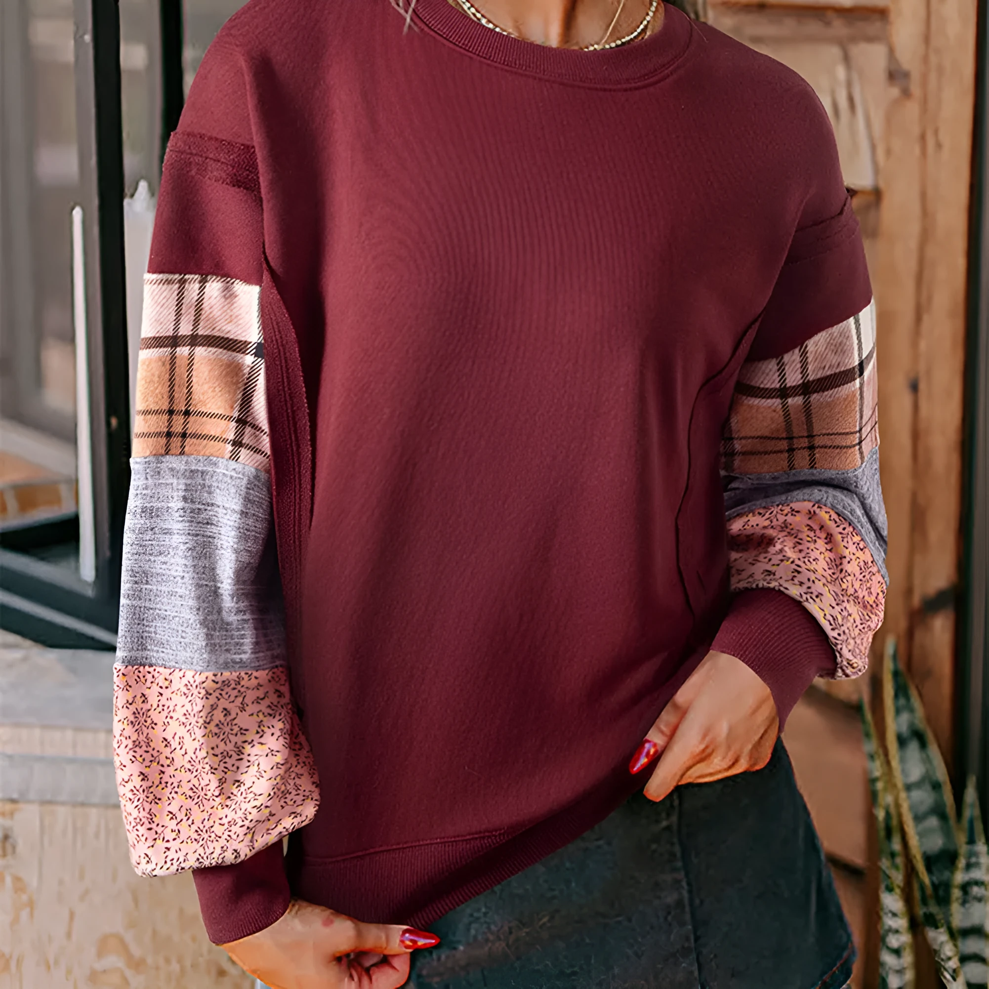 Beige and red women's loose-fit plaid long-sleeved polyester top on a hanger.