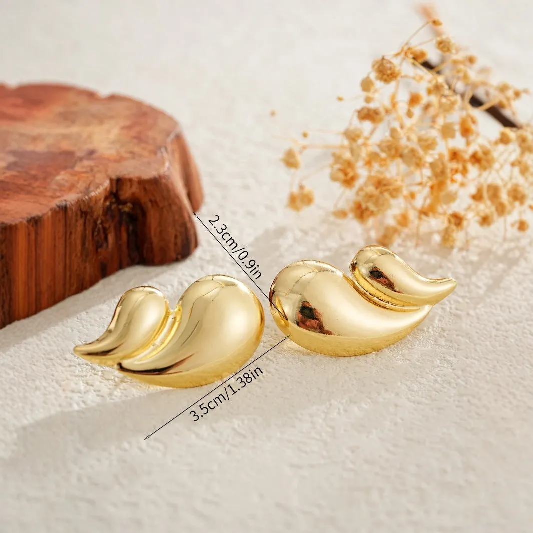 Gold water droplet minimalist dangle drop earrings on a white background