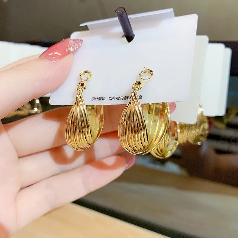 Twisted metal eardrop earring real gold plated round geometric drop earring gold colour stranded multi-layer design