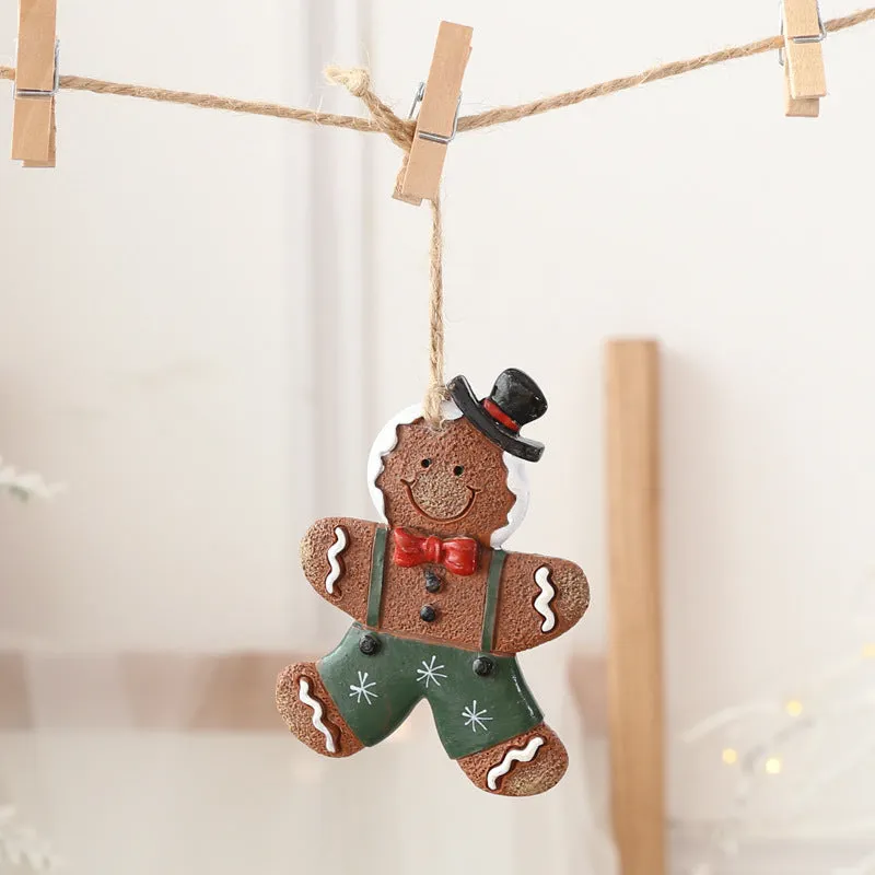 Small resin Christmas tree pendant ornament with a snowman figure holding a broom