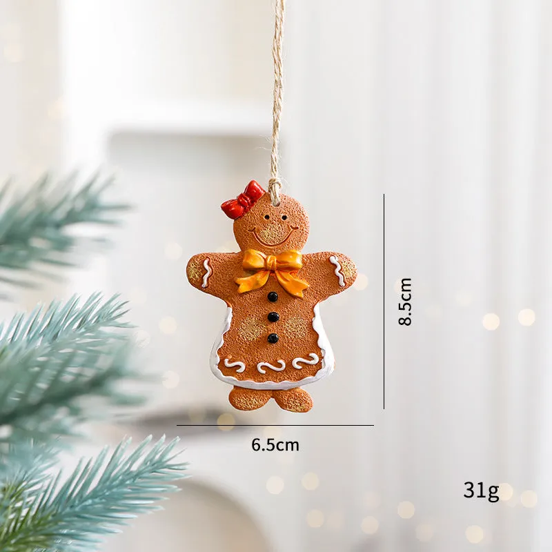 Small resin Christmas tree pendant ornament with a snowman figure holding a broom