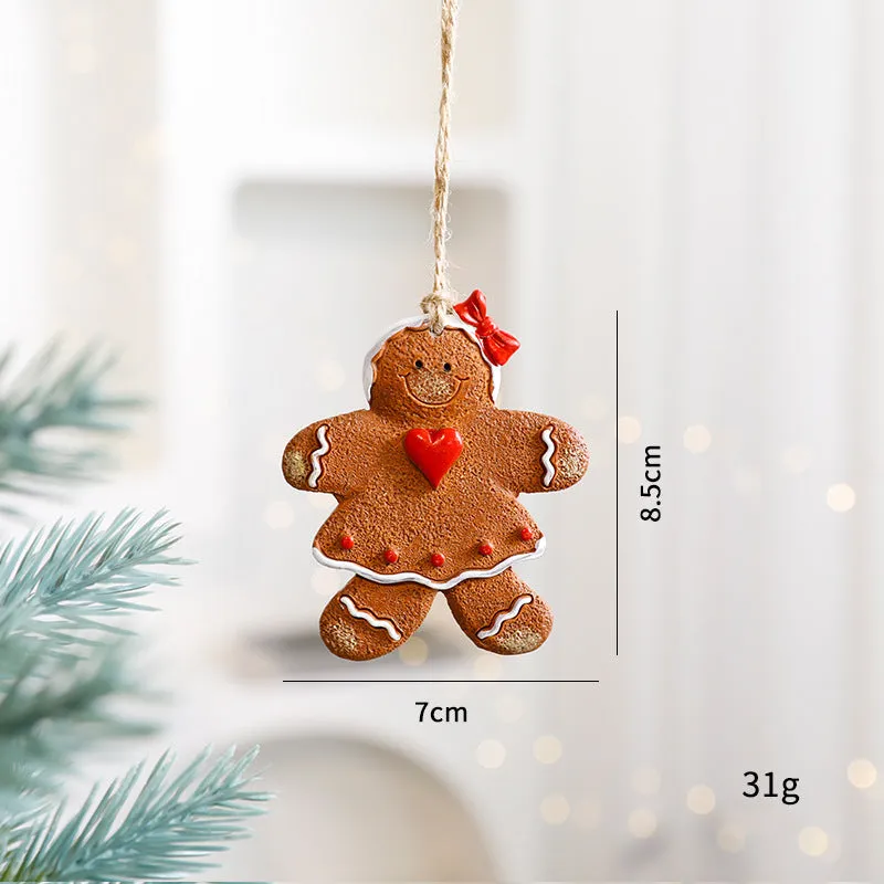 Small resin Christmas tree pendant ornament with a snowman figure holding a broom