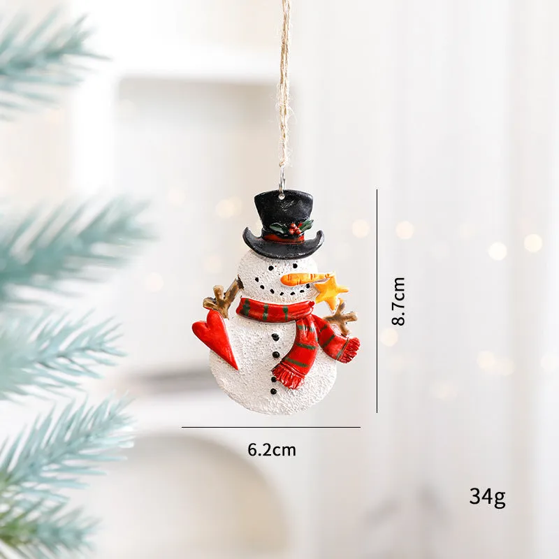 Small resin Christmas tree pendant ornament with a snowman figure holding a broom