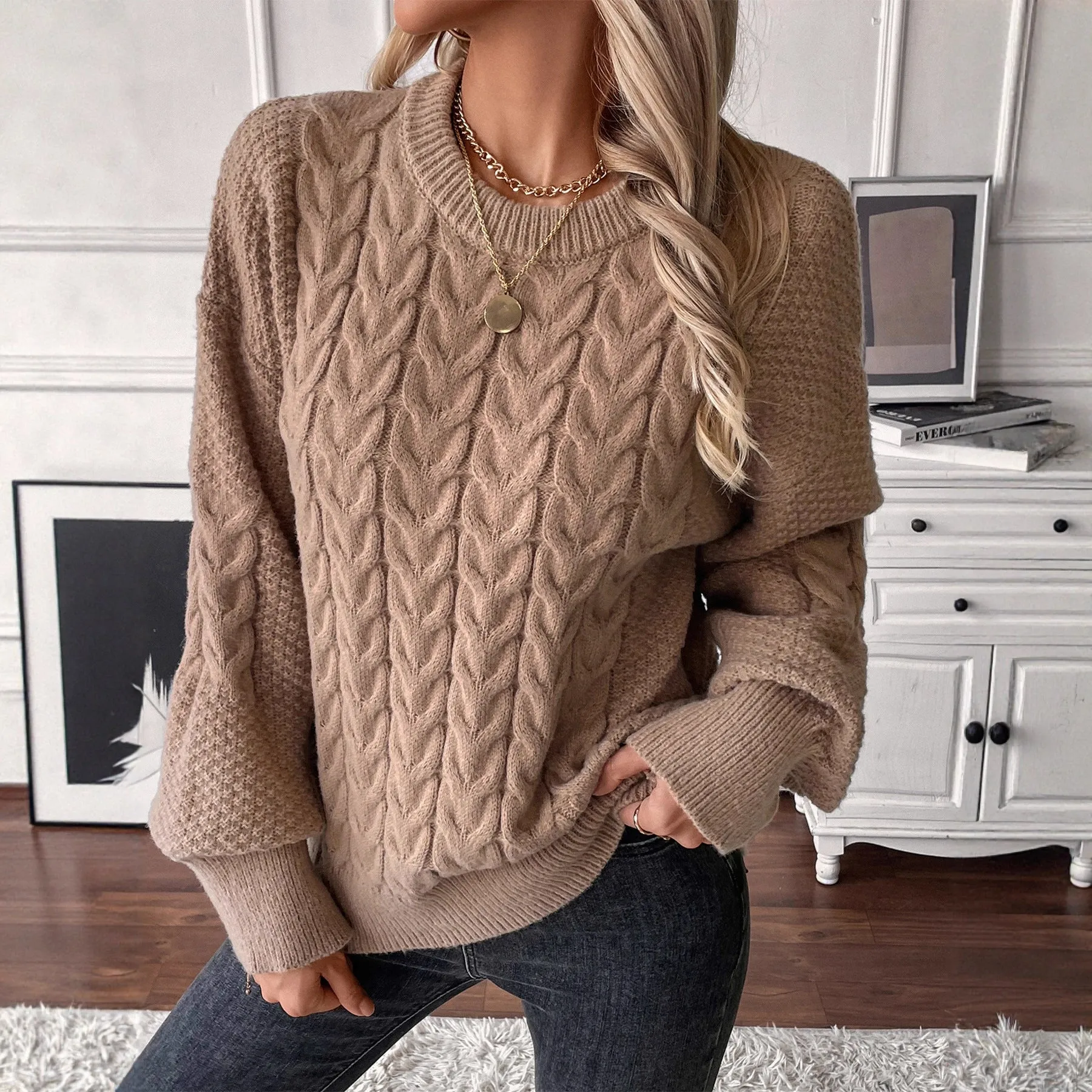 Beige women's loose round neck casual pullover sweater with textured thread detail on a hanger.