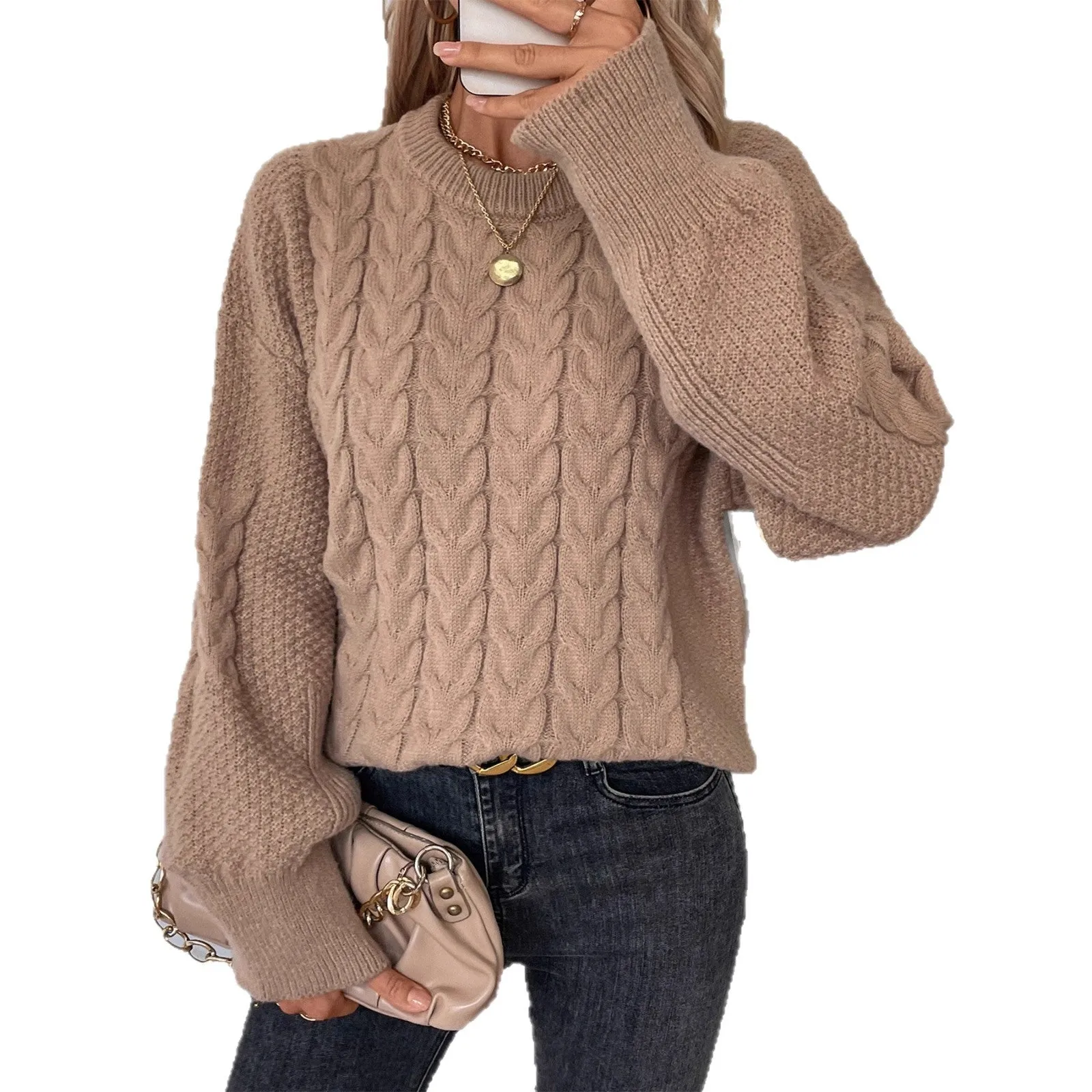 Beige women's loose round neck casual pullover sweater with textured thread detail on a hanger.