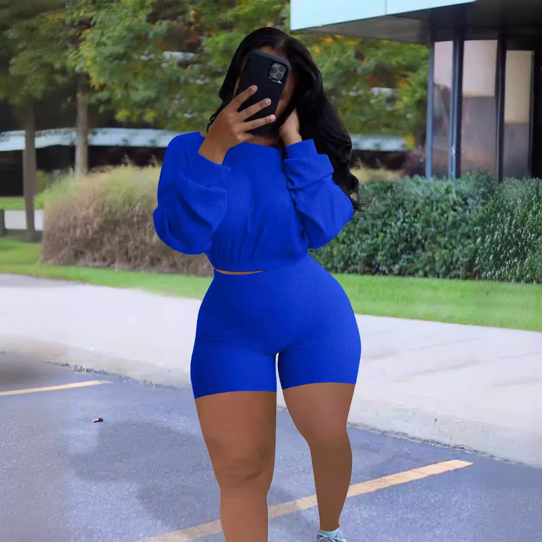 Off-the-shoulder long sleeve top and shorts two-piece set in a solid colour with a sunken stripe pattern.