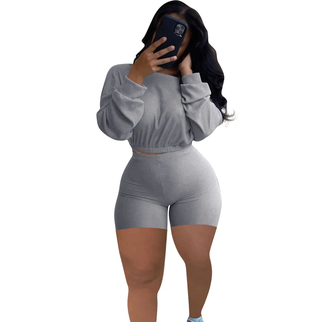 Off-the-shoulder long sleeve top and shorts two-piece set in a solid colour with a sunken stripe pattern.