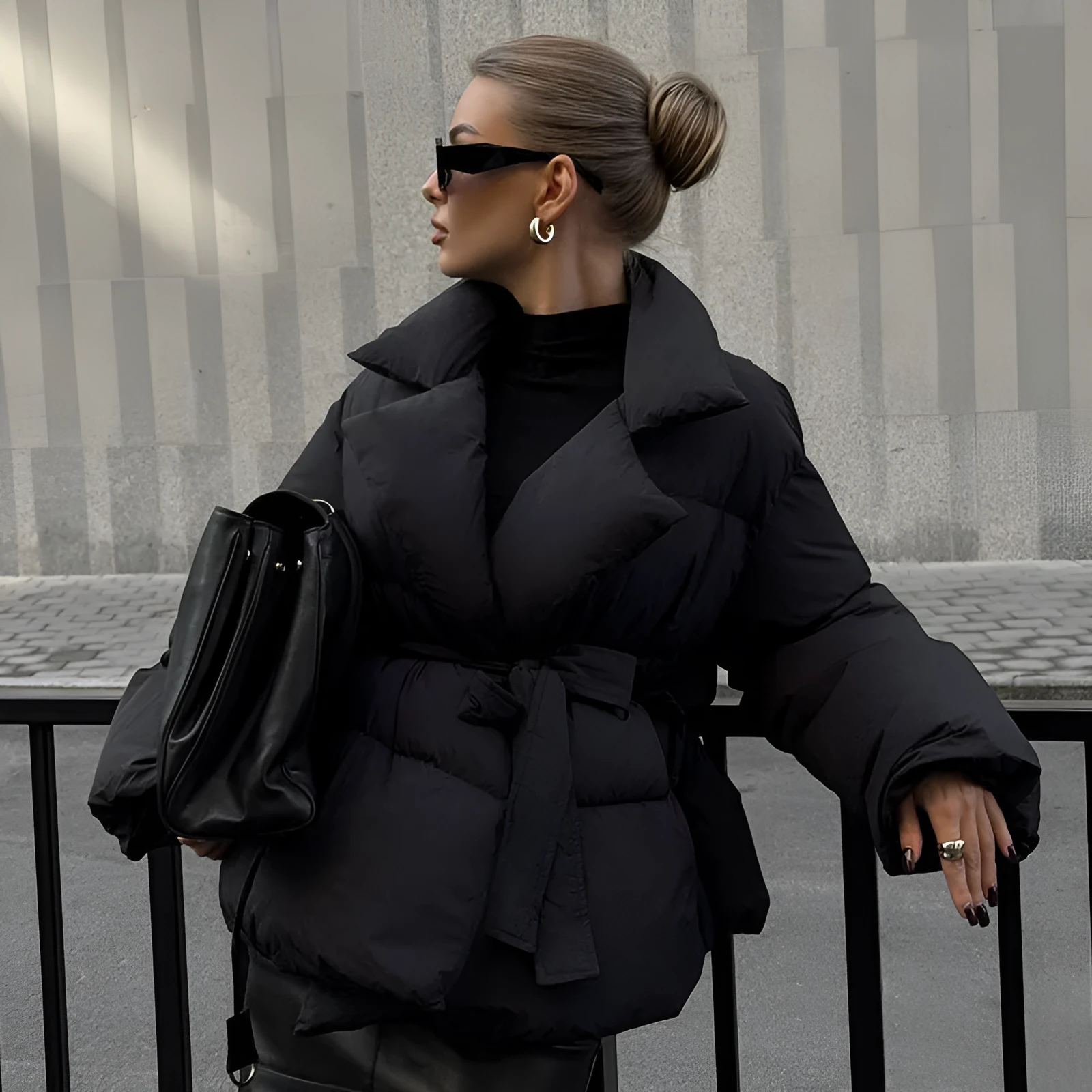 Waist-controlled lace-up lapel long sleeve polyester jacket in black with drawstring waist, front view.