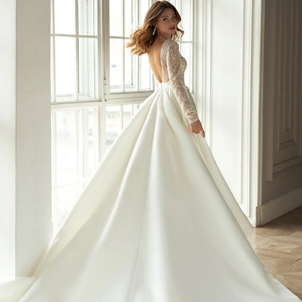 Women's white long sleeve hollow-out dress with gilded detailing, long skirt, and mid-waist cut
