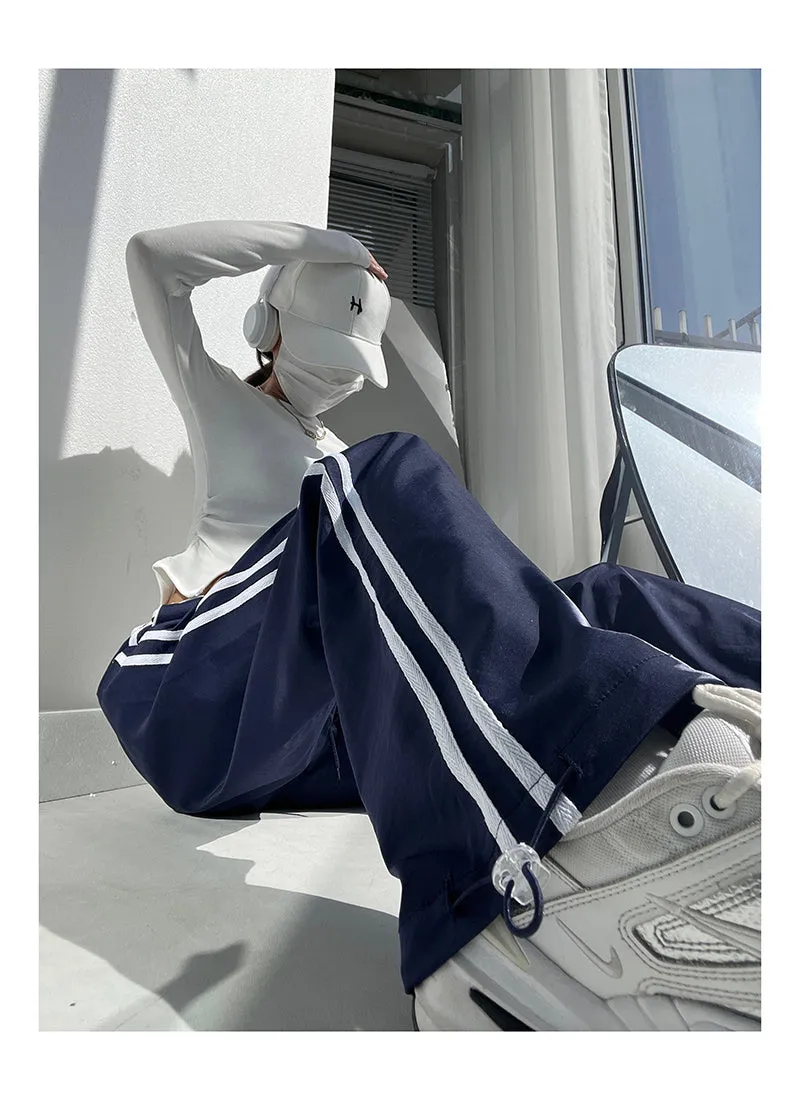 Women's navy blue loose straight pants with white contrast ribbon parallel bars detail and low waist