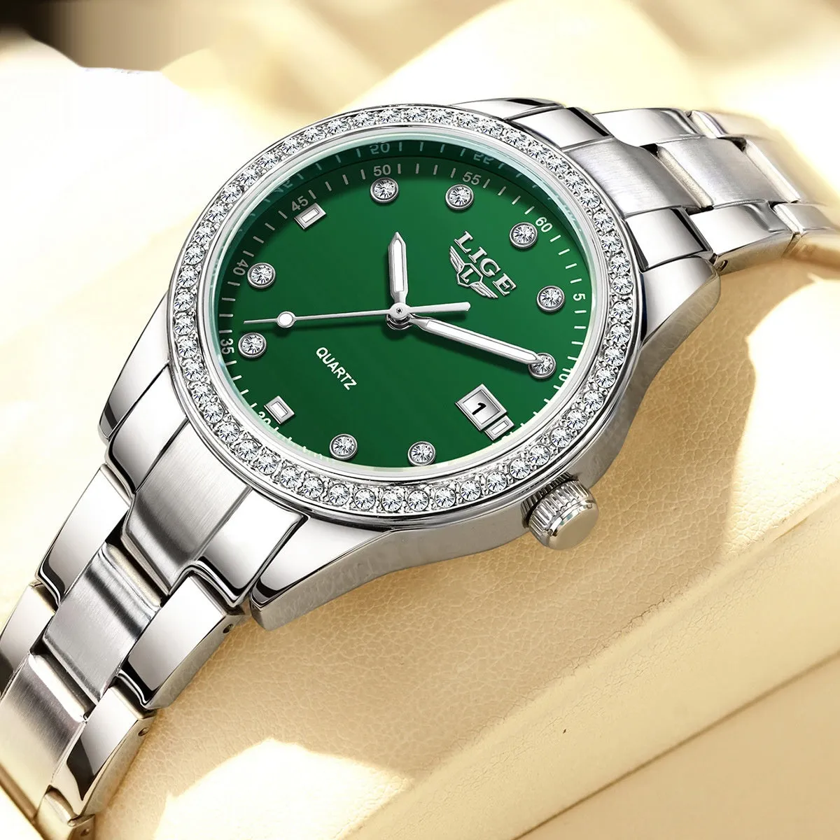 Silver fashion quartz watch with diamond markers on a 34mm stainless steel case and luminous hands.