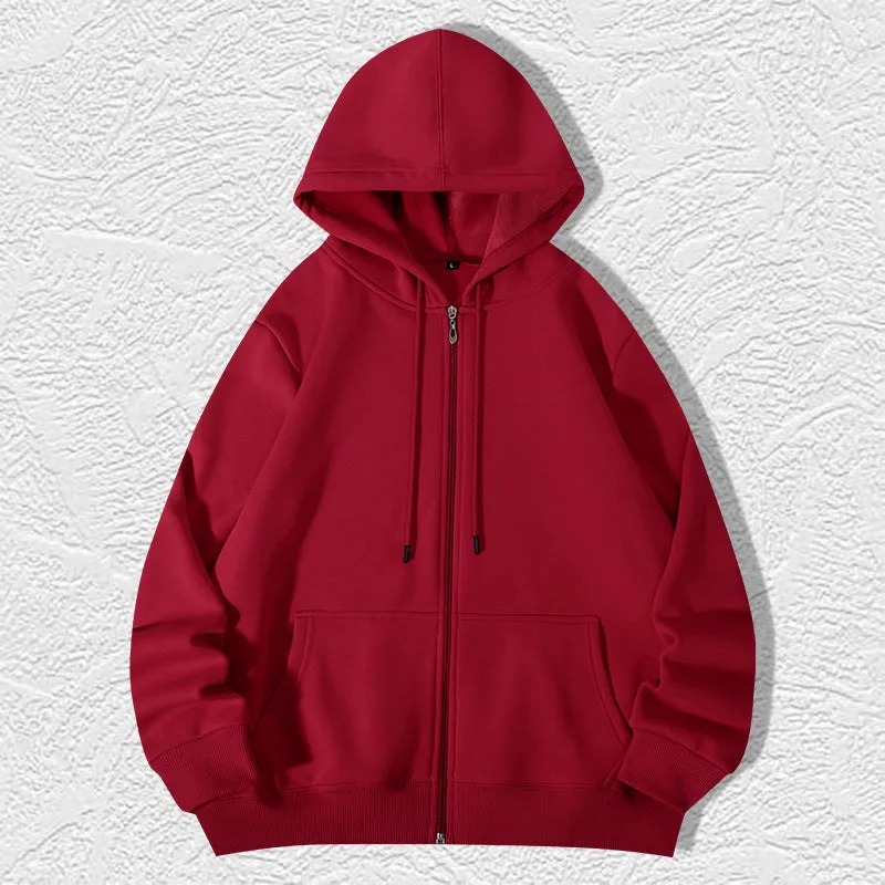 Man wearing a beige heavyweight zip-up hooded sweater, showing top-stitched pockets and loose fit.