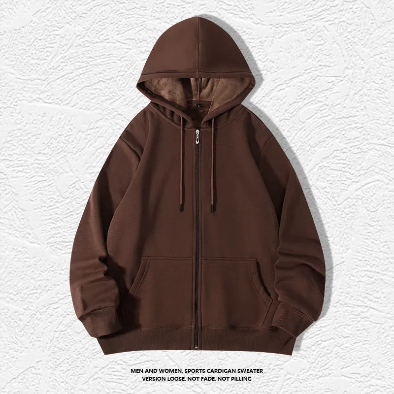 Man wearing a beige heavyweight zip-up hooded sweater, showing top-stitched pockets and loose fit.