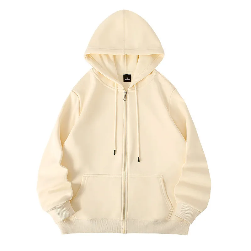 Man wearing a beige heavyweight zip-up hooded sweater, showing top-stitched pockets and loose fit.