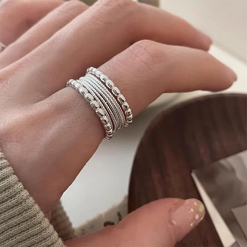 Adjustable geometric ring with woven twisted copper alloy construction