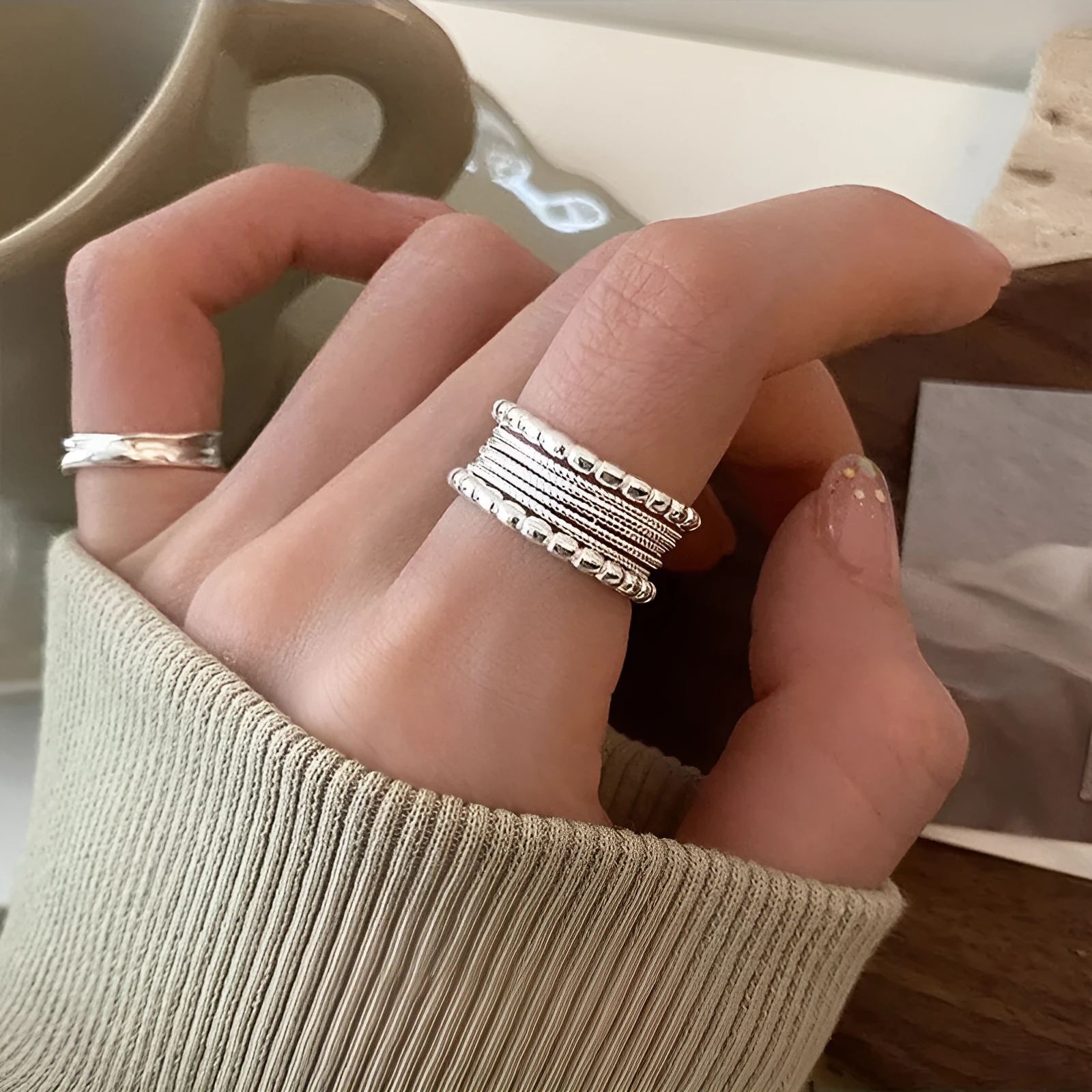 Adjustable geometric ring with woven twisted copper alloy construction