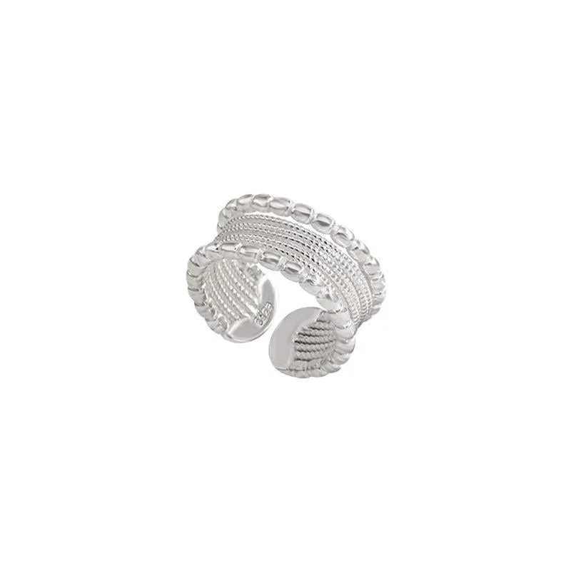 Adjustable geometric ring with woven twisted copper alloy construction