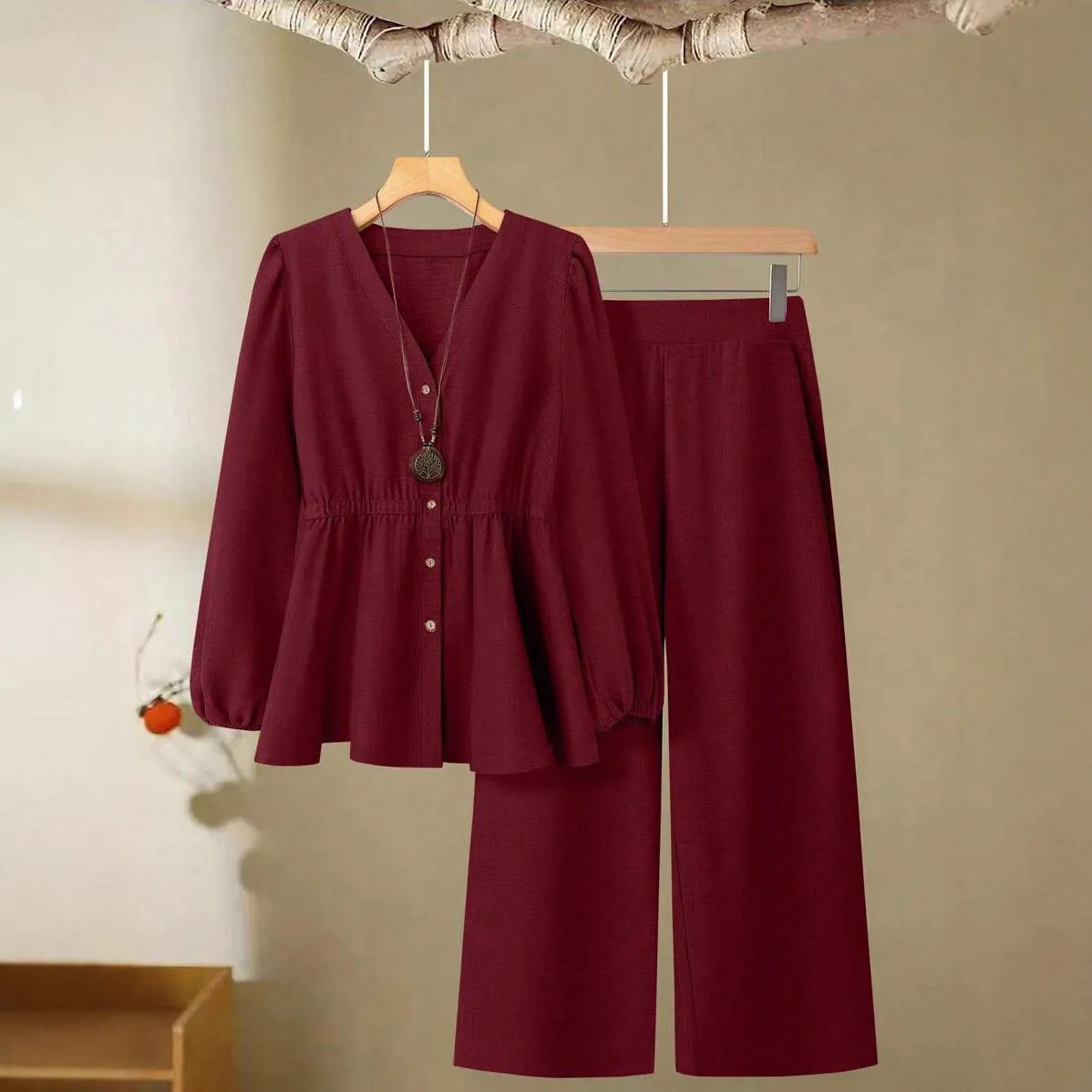 Women's woven polyester two-piece suit in wine red with button-front long-sleeved top and matching full-length trousers