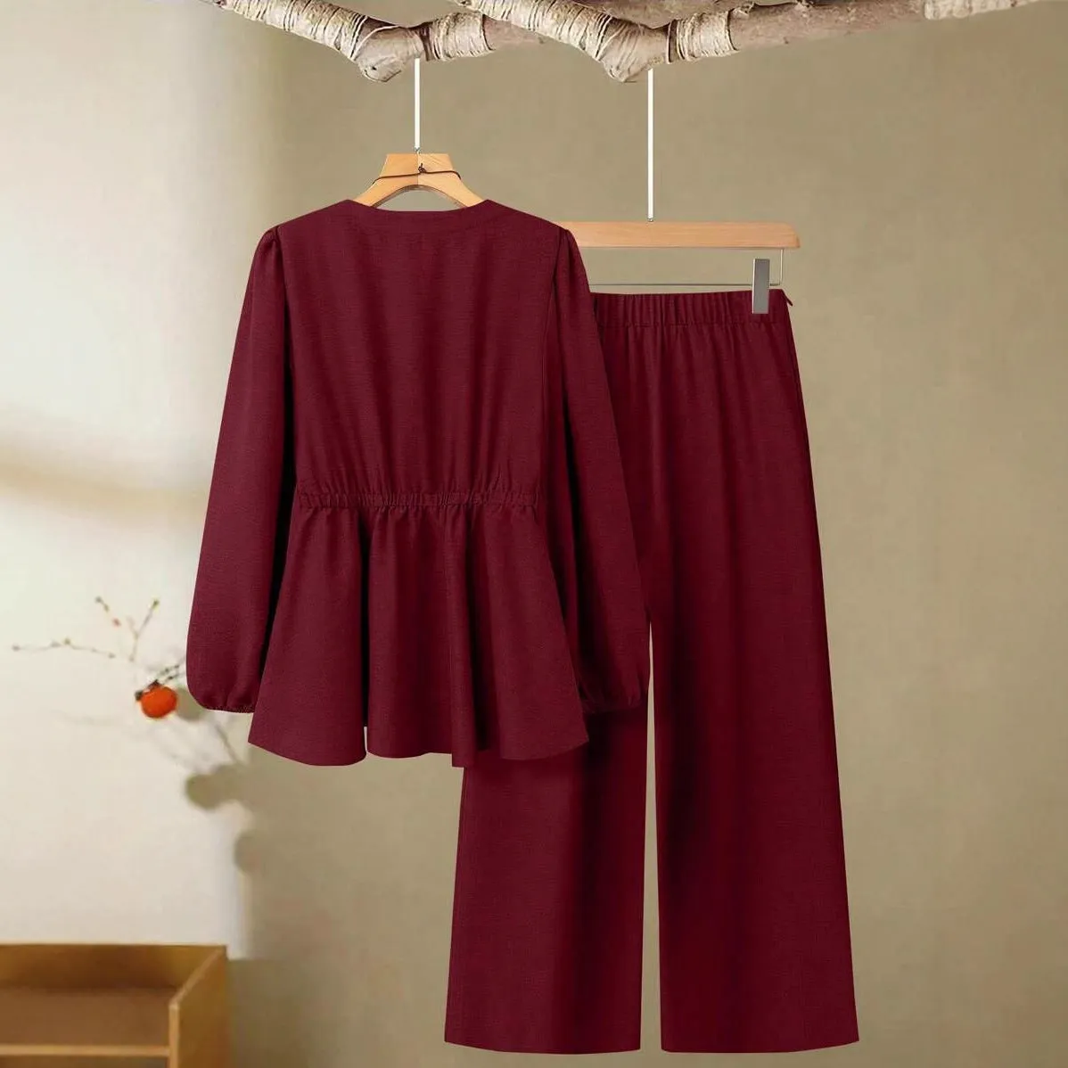 Women's woven polyester two-piece suit in wine red with button-front long-sleeved top and matching full-length trousers