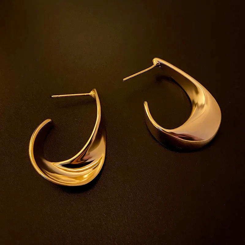 Twisted geometric metal earrings with circular design in gold or silver electroplated finish