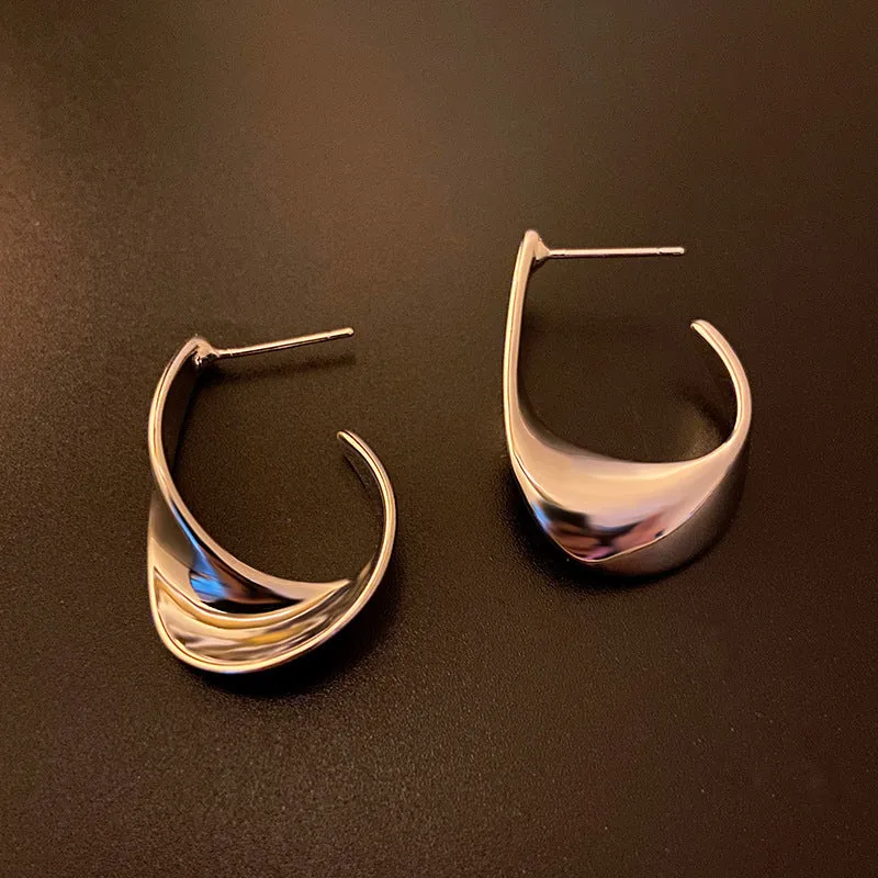 Twisted geometric metal earrings with circular design in gold or silver electroplated finish