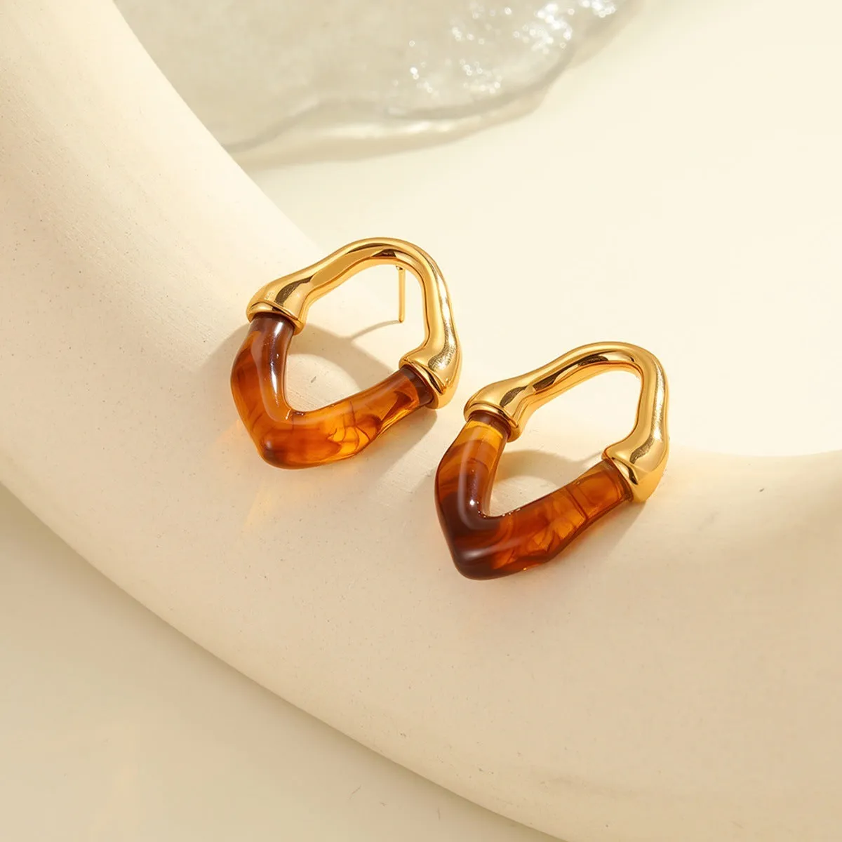 Stainless steel earrings with pink resin stitching and 18K gold plating
