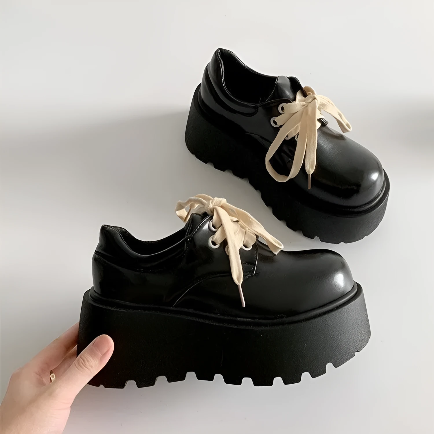 Matte black women's lace-up high-heel shoes with a thick sole and an English muffin heel.