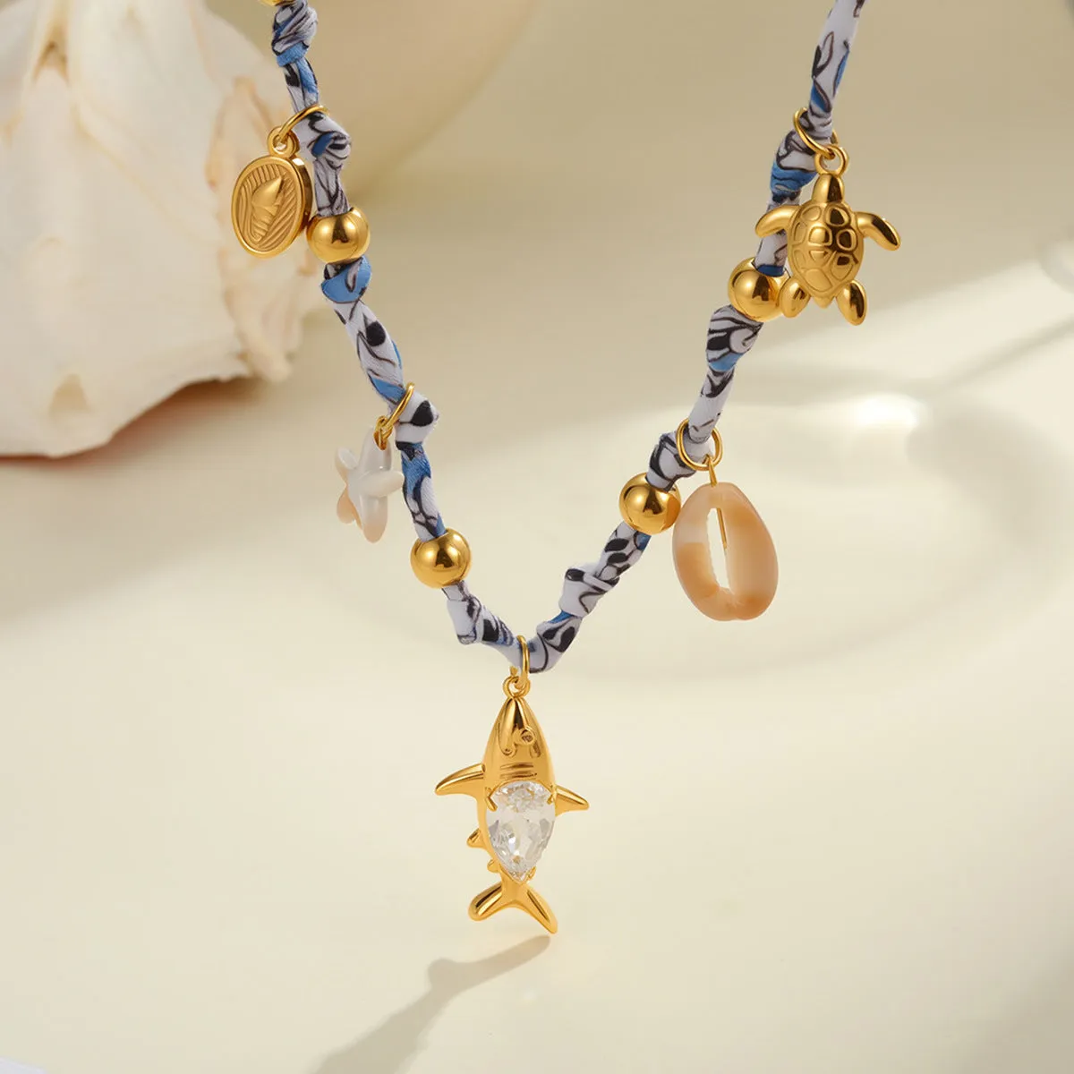 Gold starfish shell pendant on hand-knotted rope chain, 18K plated stainless steel, geometric shape