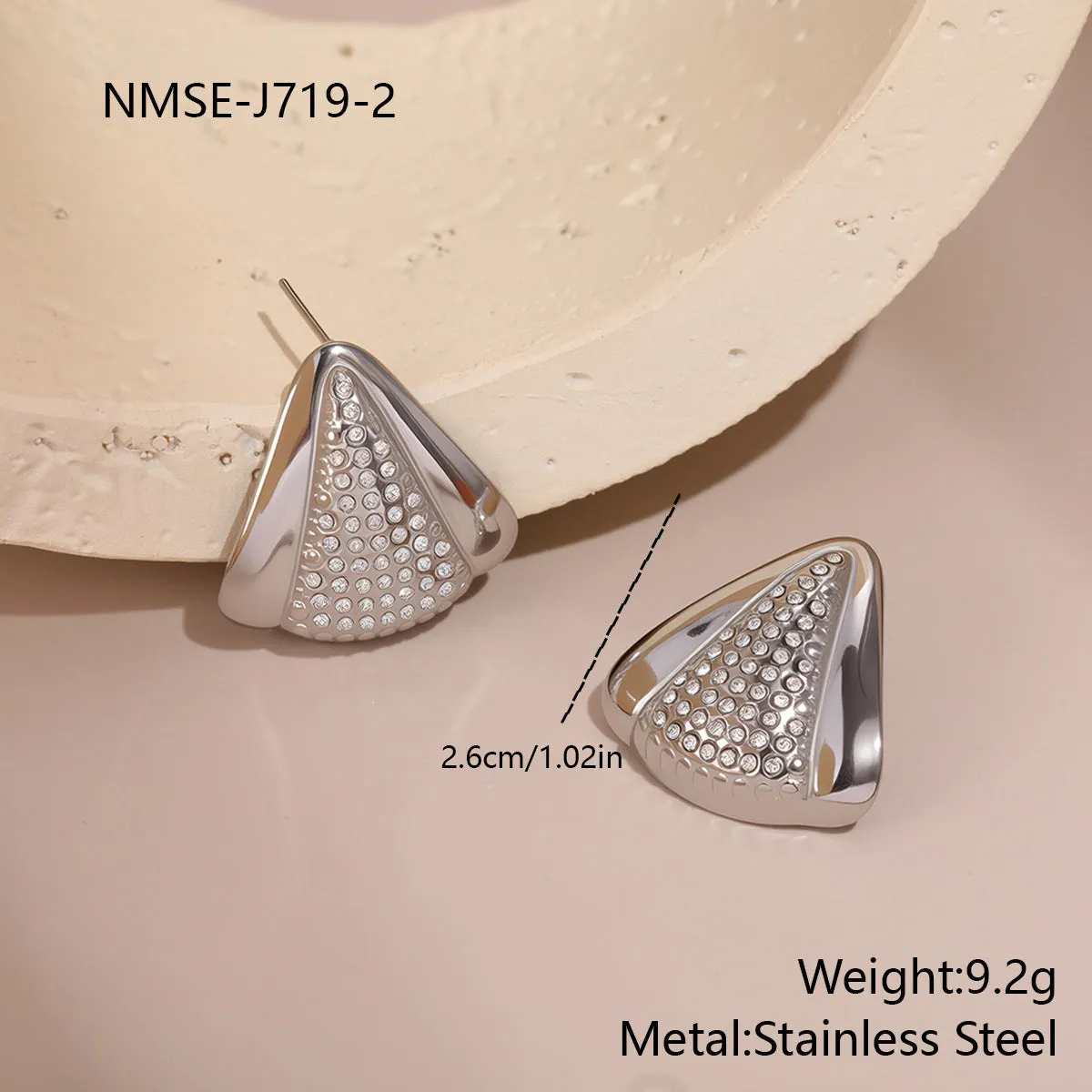 Gold triangle stainless steel geometric stud earrings with electroplated finish on white background