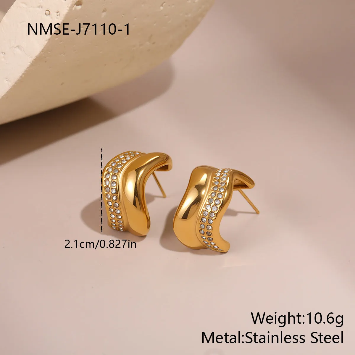 Gold triangle stainless steel geometric stud earrings with electroplated finish on white background