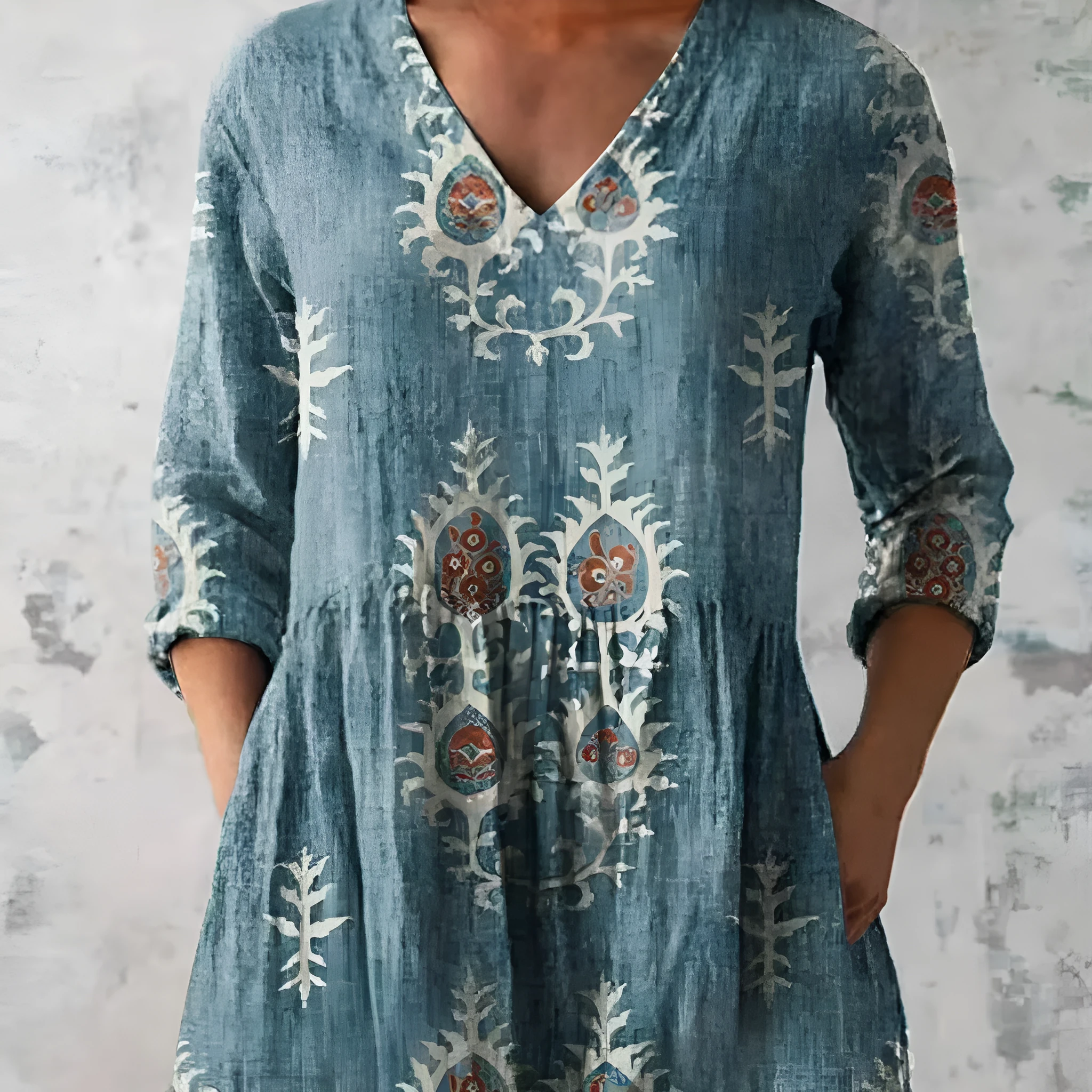 Women's loose-fit dress with blue and white wave pattern print and three-quarter length sleeves.