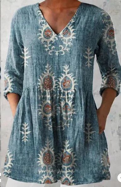 Women's loose-fit dress with blue and white wave pattern print and three-quarter length sleeves.