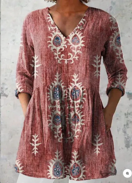 Women's loose-fit dress with blue and white wave pattern print and three-quarter length sleeves.