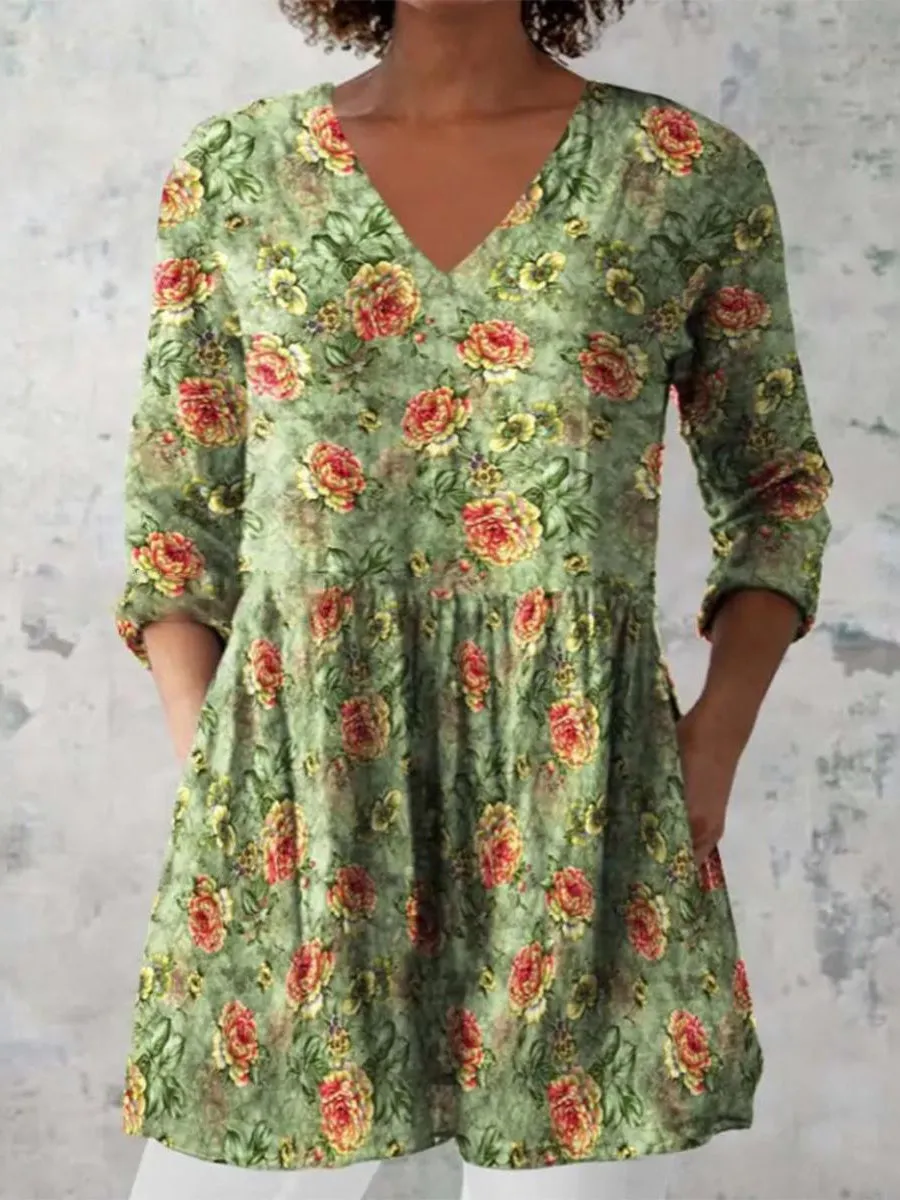 Women's loose-fit dress with blue and white wave pattern print and three-quarter length sleeves.