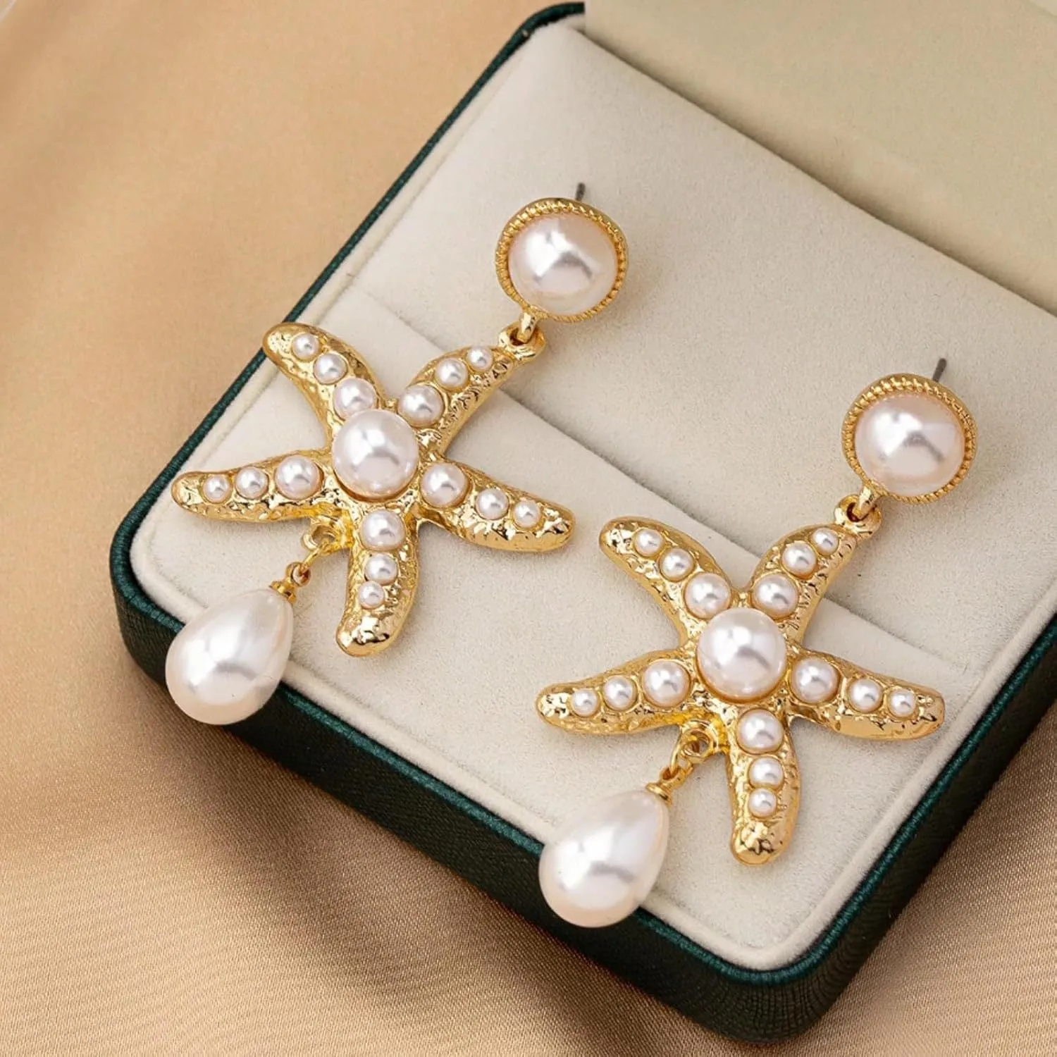 Women's silver-tone pearl starfish earrings on light background