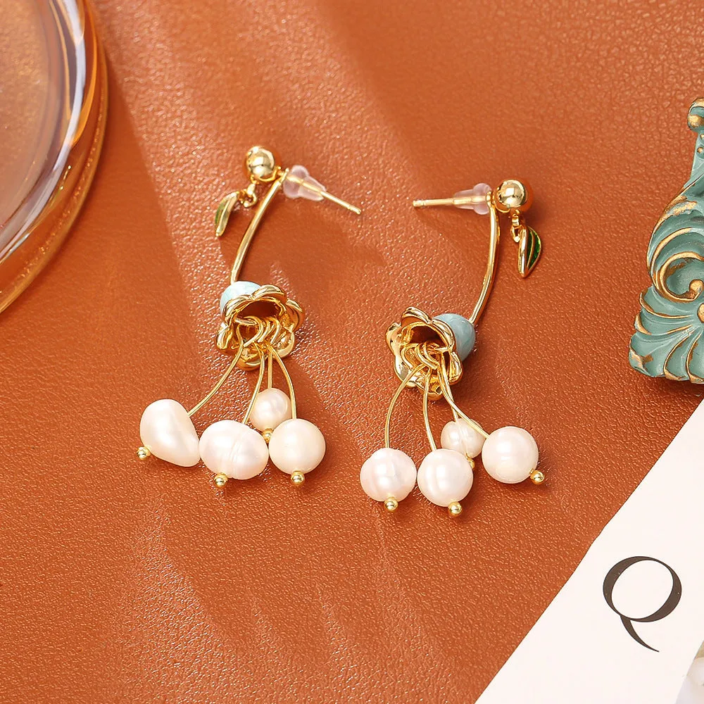 Natural baroque pearl ear studs with 14K real gold plated lily flower copper setting on white background