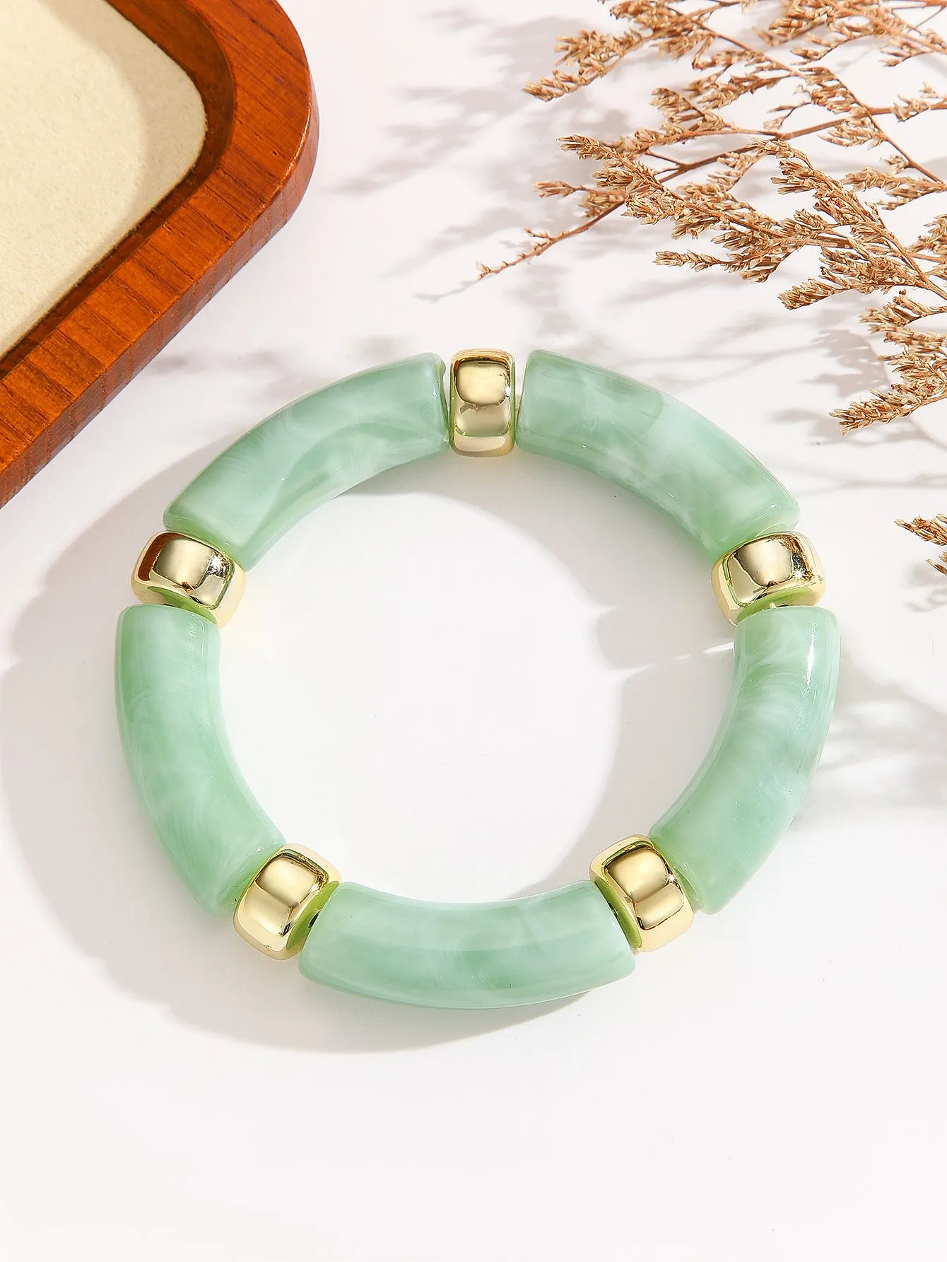 Acrylic bent tube bracelet in selected colour, lightweight and adjustable design.