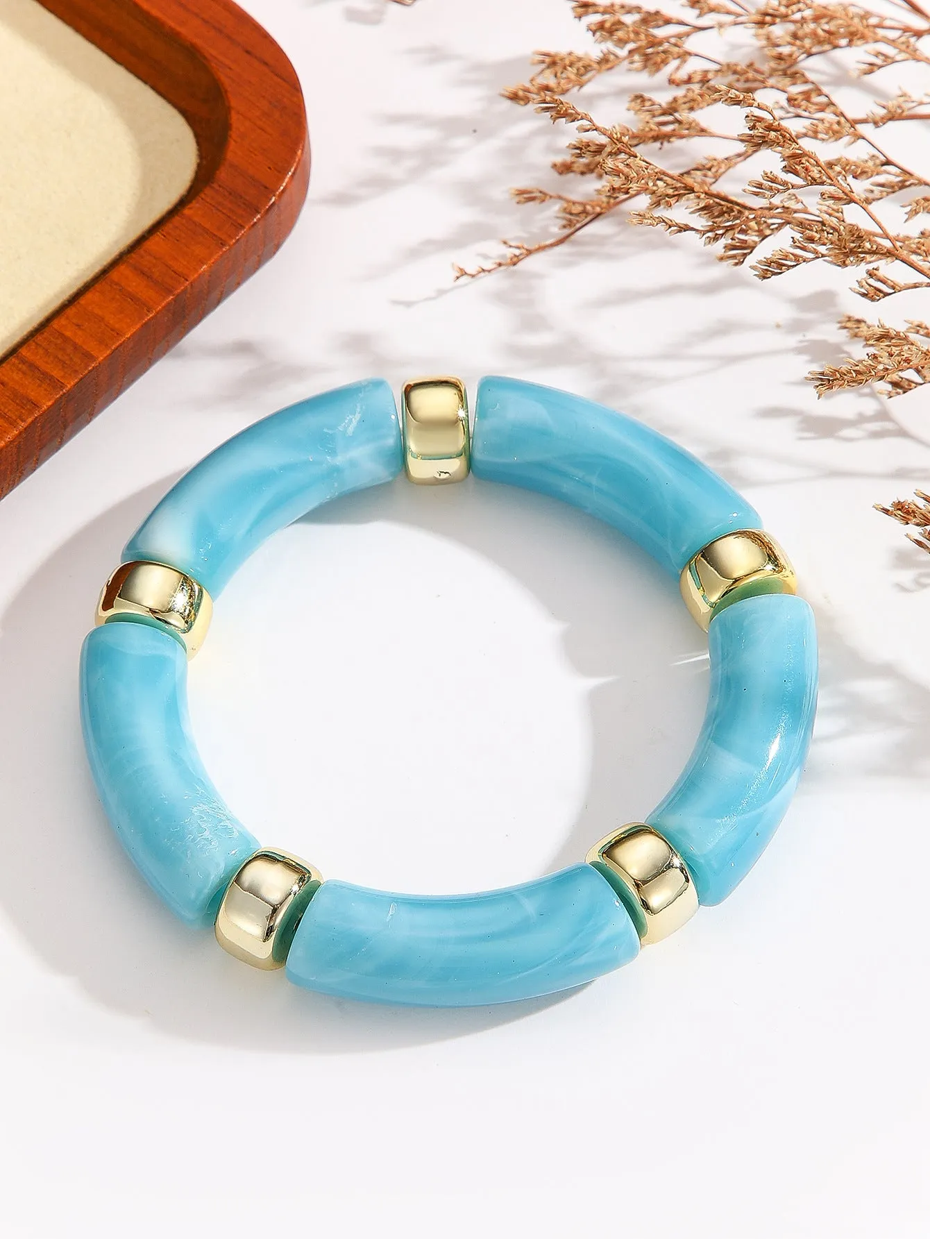 Acrylic bent tube bracelet in selected colour, lightweight and adjustable design.