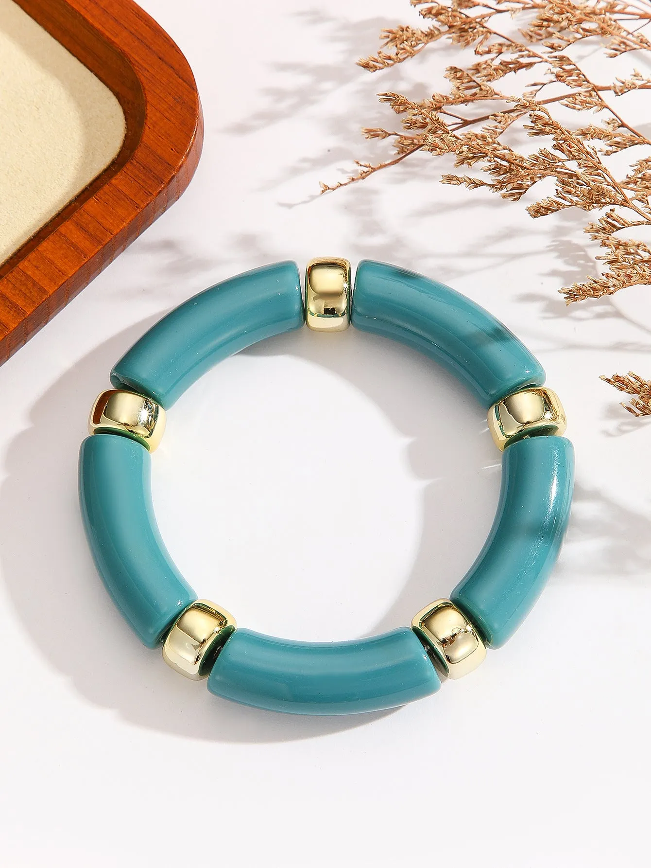 Acrylic bent tube bracelet in selected colour, lightweight and adjustable design.