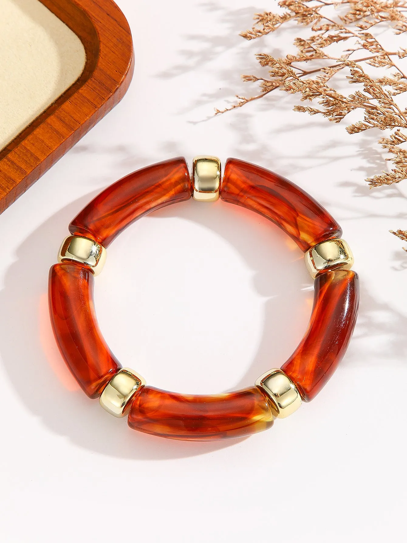 Acrylic bent tube bracelet in selected colour, lightweight and adjustable design.