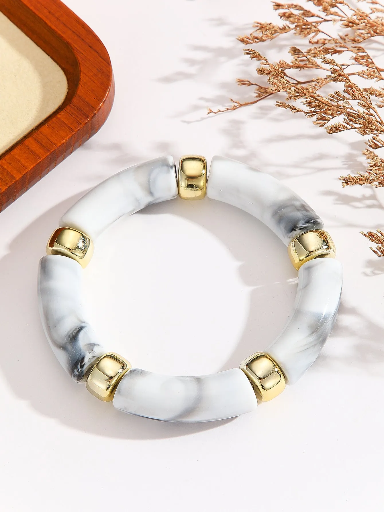 Acrylic bent tube bracelet in selected colour, lightweight and adjustable design.