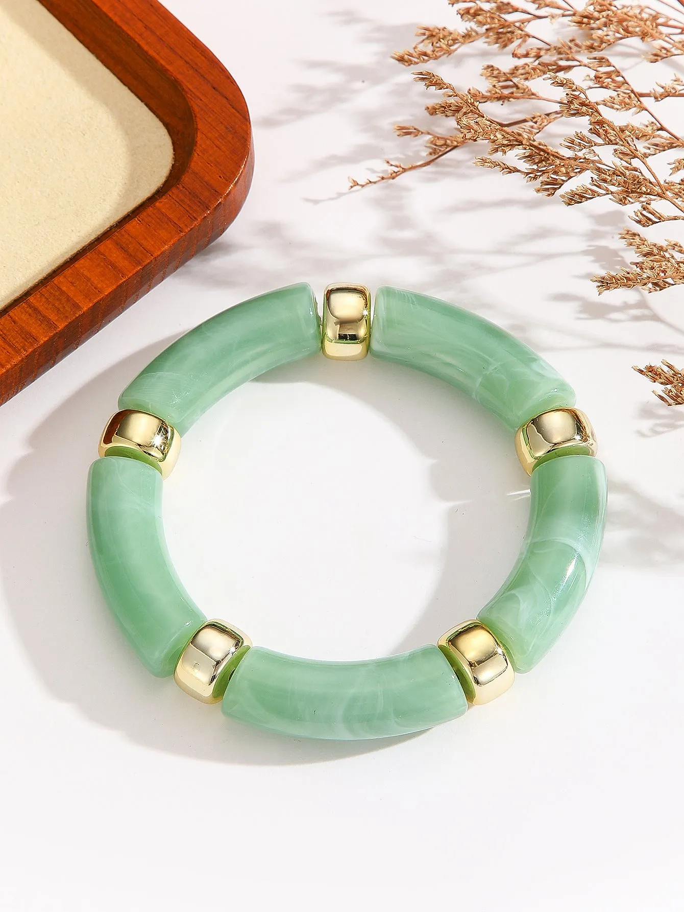 Acrylic bent tube bracelet in selected colour, lightweight and adjustable design.