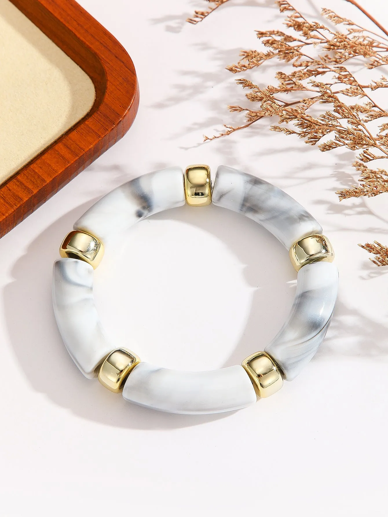 Acrylic bent tube bracelet in selected colour, lightweight and adjustable design.