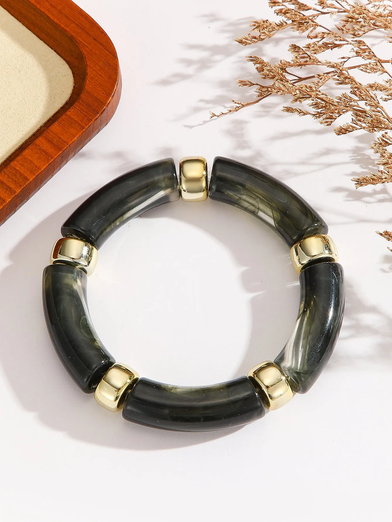 Acrylic bent tube bracelet in selected colour, lightweight and adjustable design.