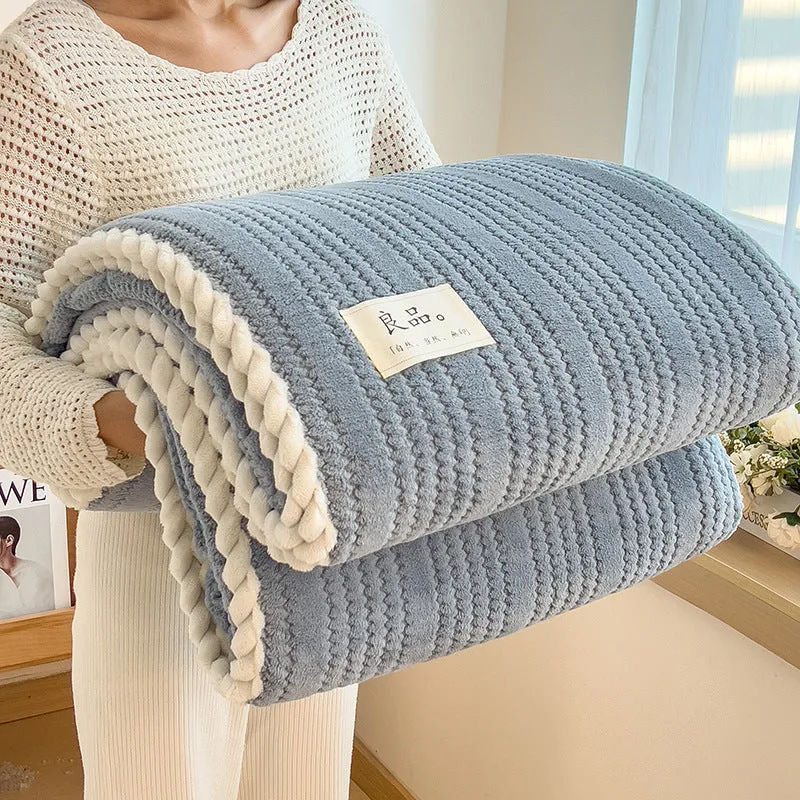 Solid colour jacquard milk velvet blanket in cream white on a bed with Nordic-style decor