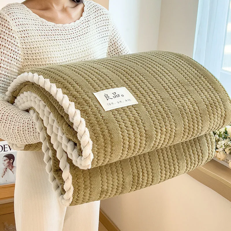 Solid colour jacquard milk velvet blanket in cream white on a bed with Nordic-style decor